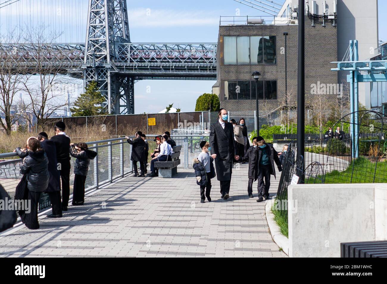 New York, USA - May 3 2020: Hasidic Jews in Williamsburg Brooklyn in the Park and on Streets in Groups and Alone with Children During Coronavirus COVI Stock Photo