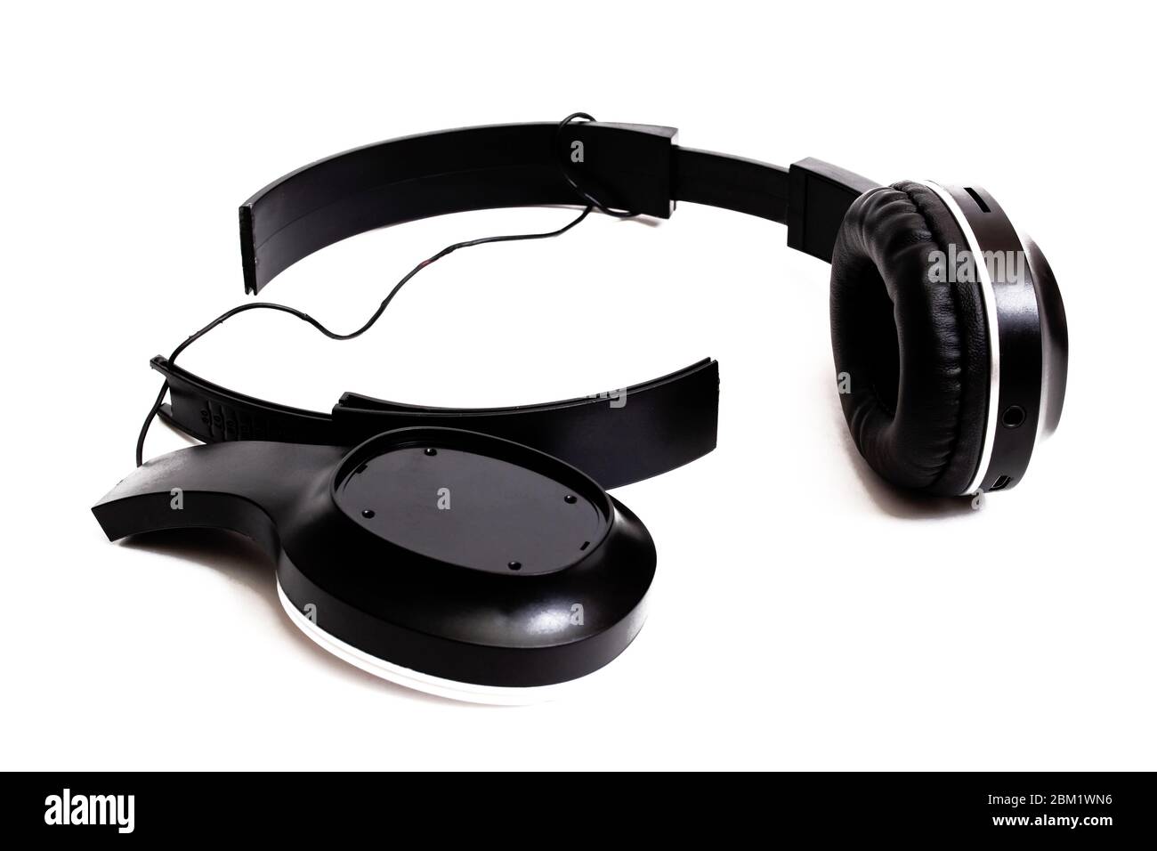 Broken black headphones isolated on white background Stock Photo - Alamy