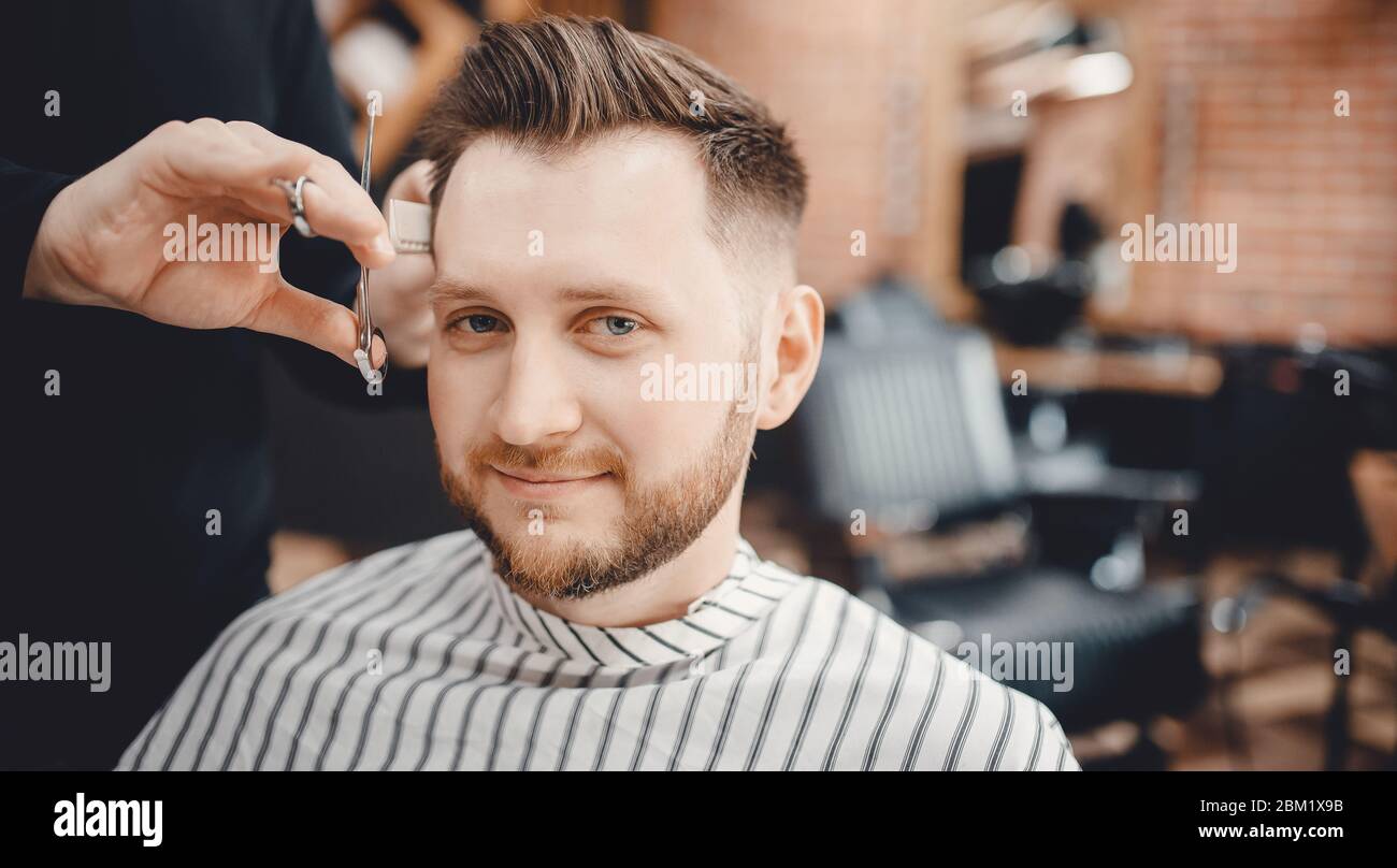 concept. Hairdressers barber haircut men in salon Stock