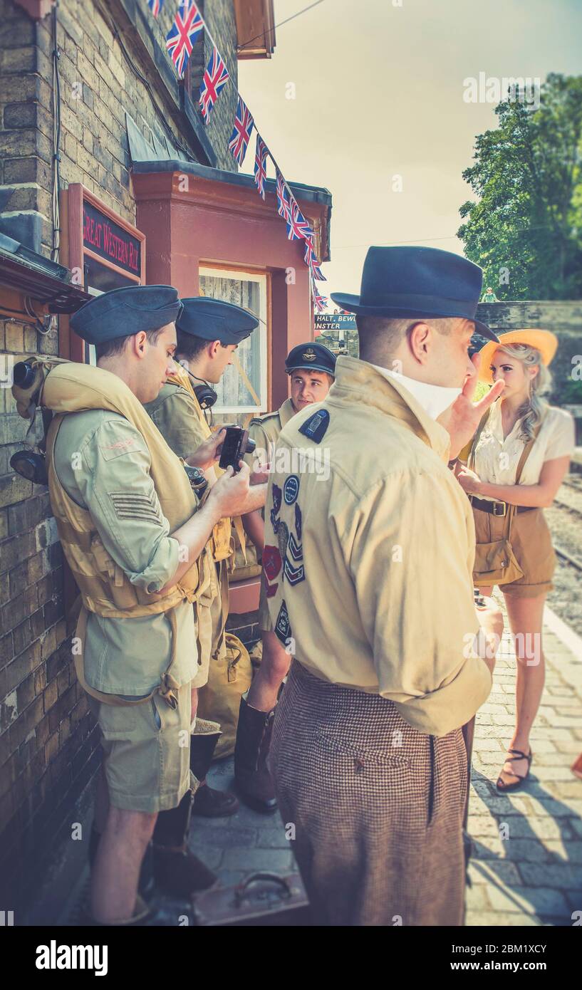 Retro vintage view of re-enactors in 1940s dress at Arley vintage train station for Severn Valley Railway 1940s WWII wartime summer event, UK. Stock Photo