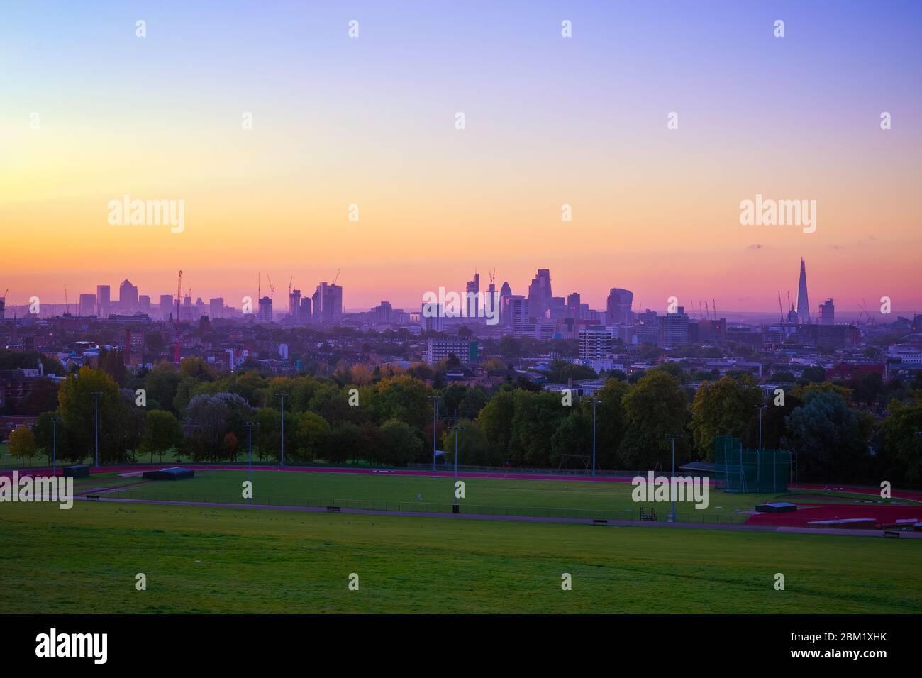 View towards London city skyline at sunrise from Parliament Hill in