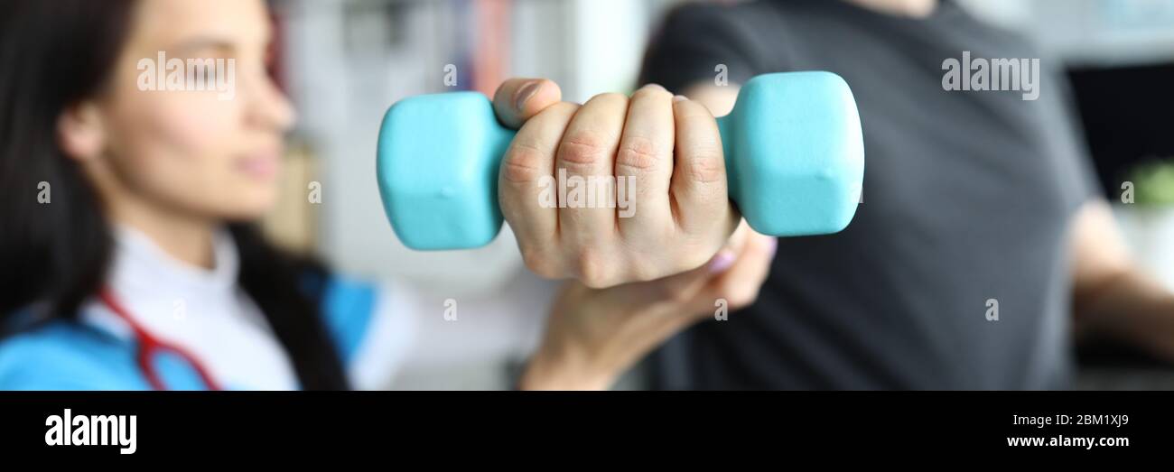 Man on stroller doing exercises with dumbbells Stock Photo