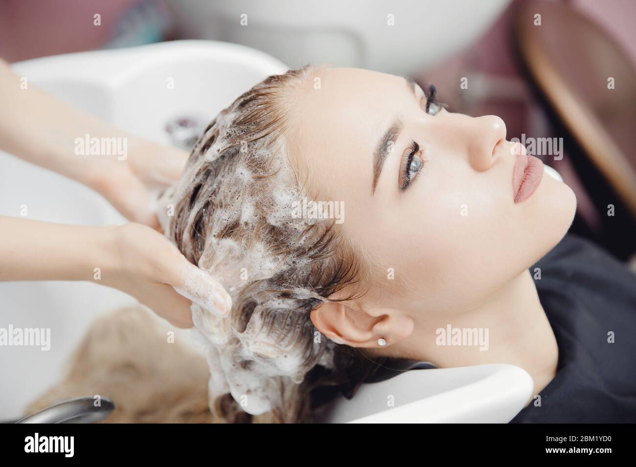 Beautiful blond woman getting hair wash in beauty salon Stock Photo Alamy