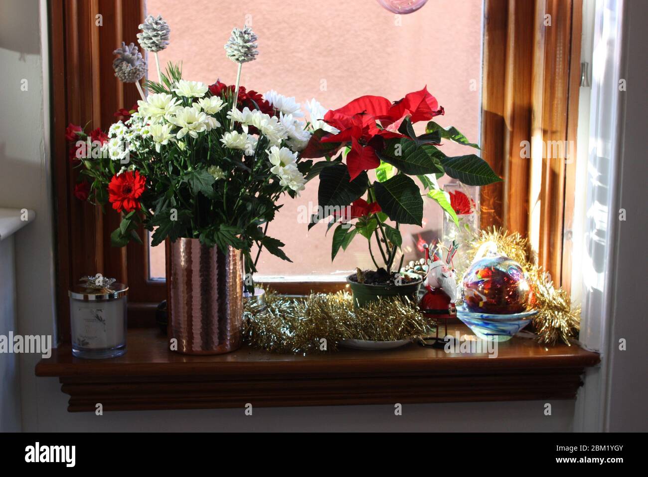 Christmas xmas decorations and flowers on windowsill Stock Photo