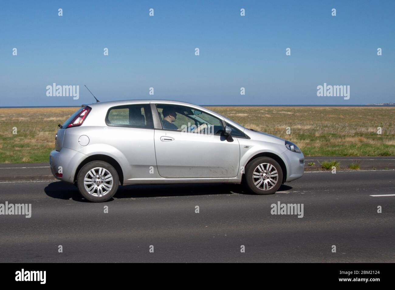 2013 silver Fiat Punto Easy; Vehicular traffic moving vehicles, driving  vehicle on UK roads, motors, motoring in Southport, UK Stock Photo - Alamy