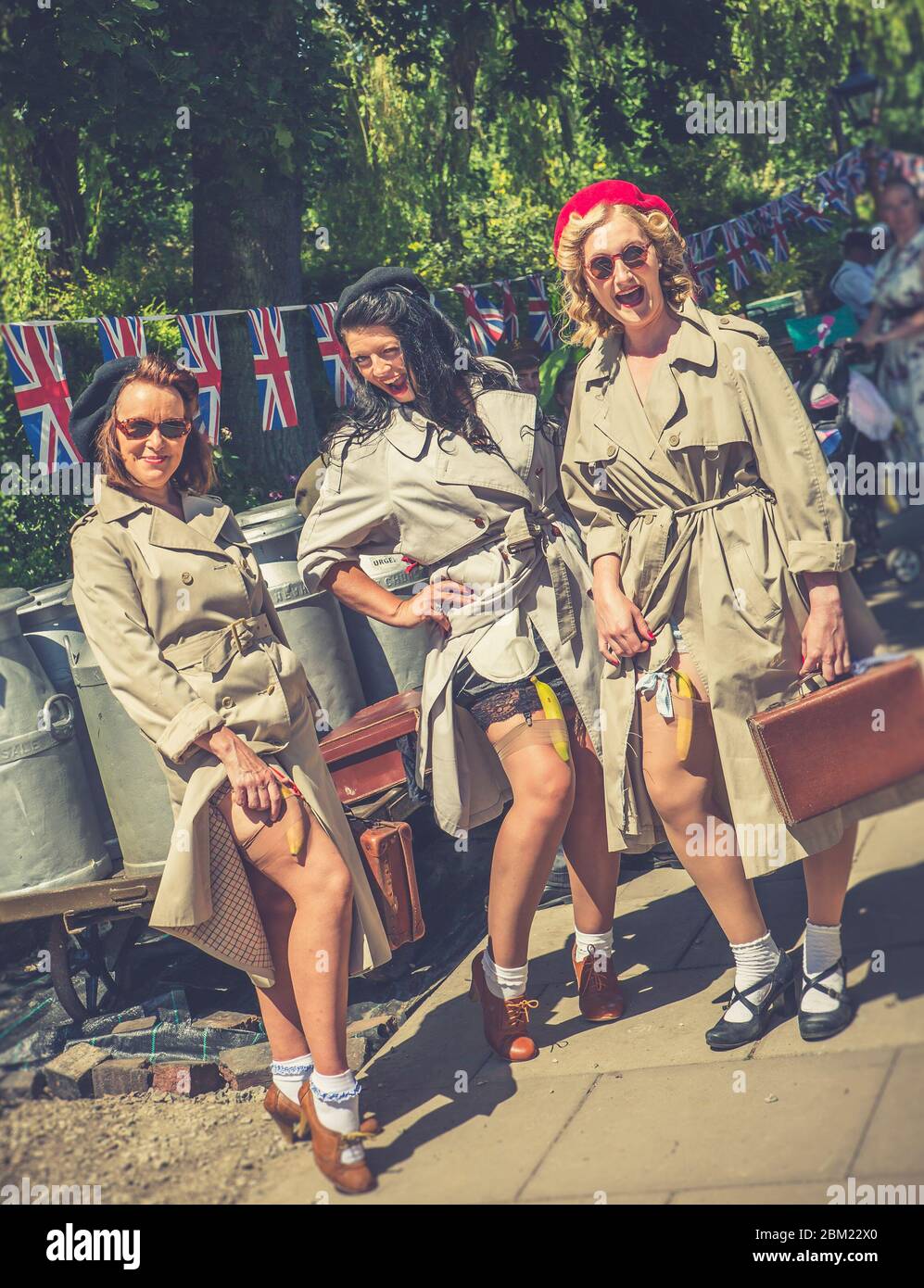 Retro view of 1940s women re-enactors having fun as ladies of the French Resistance from 'Allo 'Allo TV show, Severn Valley Railway WW2  summer event. Stock Photo