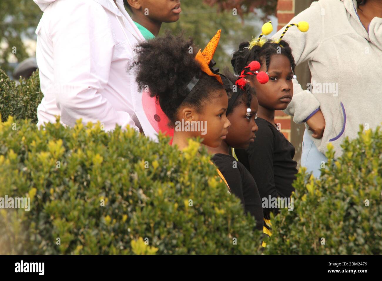 U.S.A. Children on trick-or --treat with their families during Halloween. Stock Photo