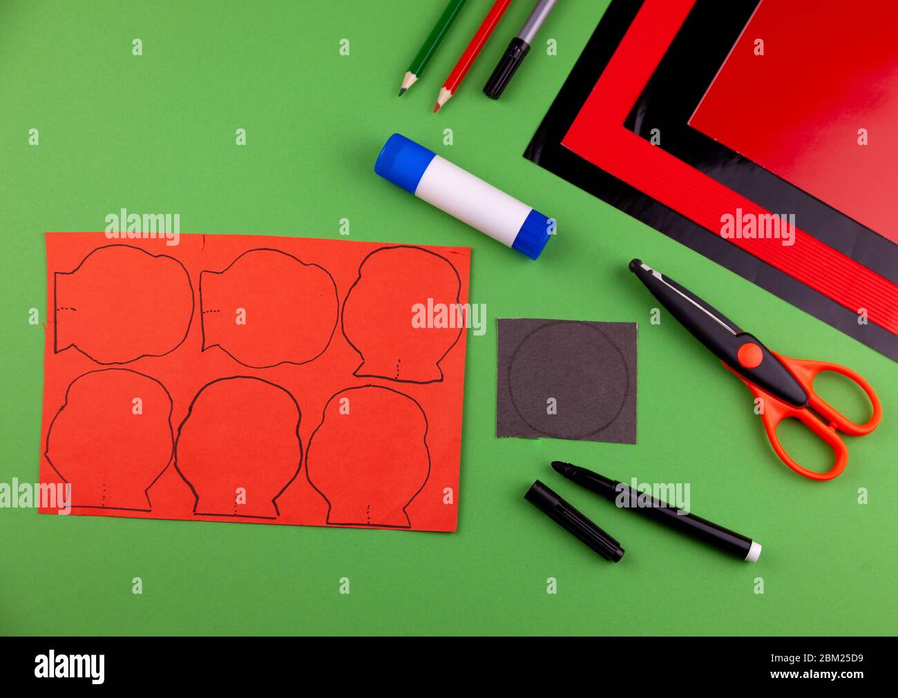 Step 2. Step by step instructions. How to make a red poppy from colored paper. Creative crafts for Victory Day. Memorial Day of the victims of the war Stock Photo
