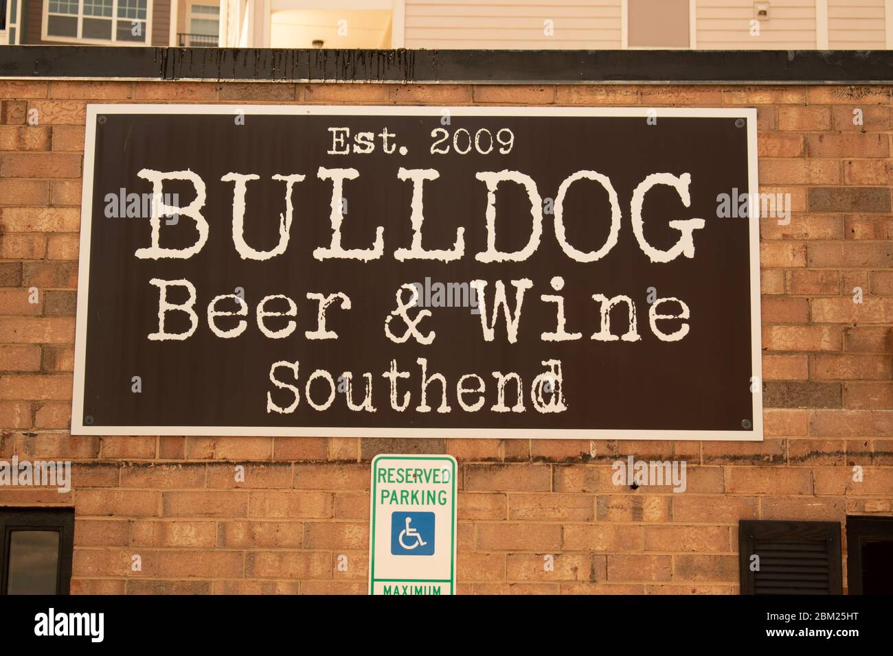 Charlotte, NC/USA - May 14, 2019: Brand signage for 'Bulldog Beer & Wine Southend' on the  facade of the brick building in black and white.  Establish Stock Photo