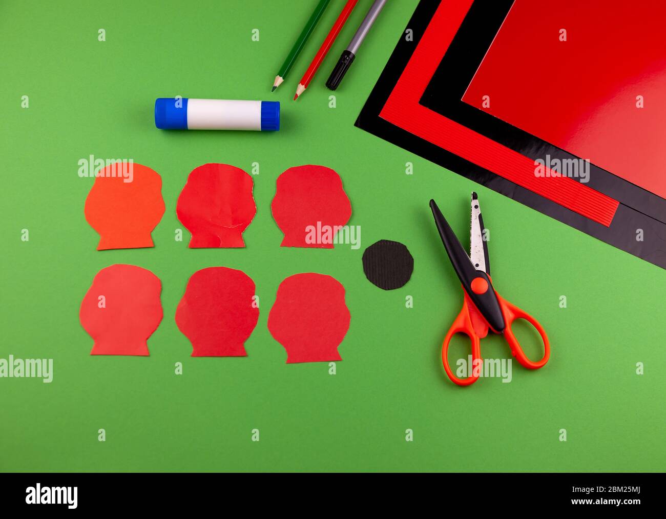 Step 3. Step by step instructions. How to make a red poppy from colored paper. Creative crafts for Victory Day. Memorial Day of the victims of the war Stock Photo