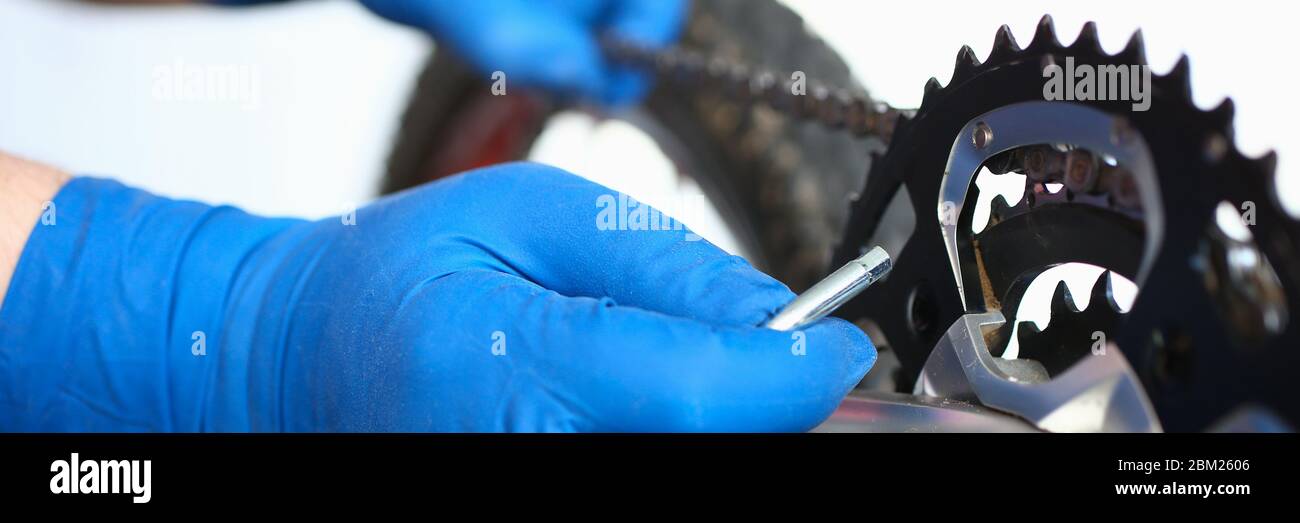 Gloved hands guy repair mechanical part bicycle Stock Photo