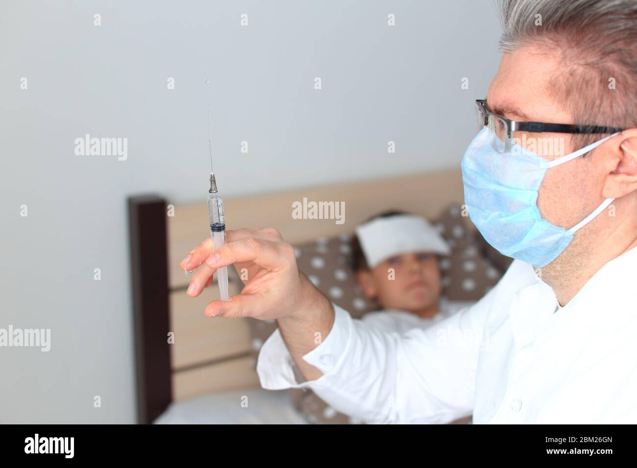 The doctor is going to give an injection to a sick child Stock Photo ...