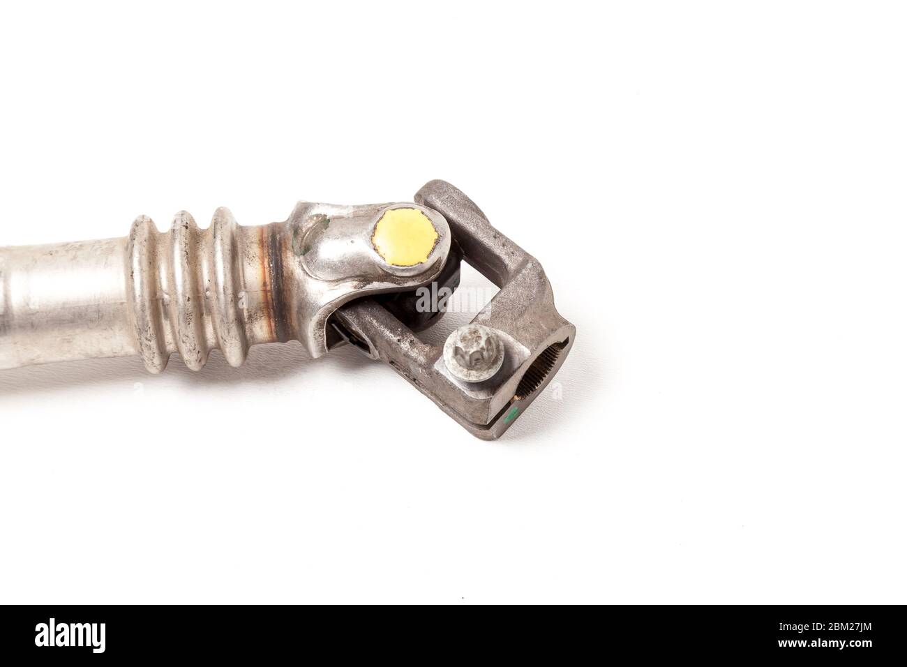 The car’s spare part is a metal cardan shaft on a white background with