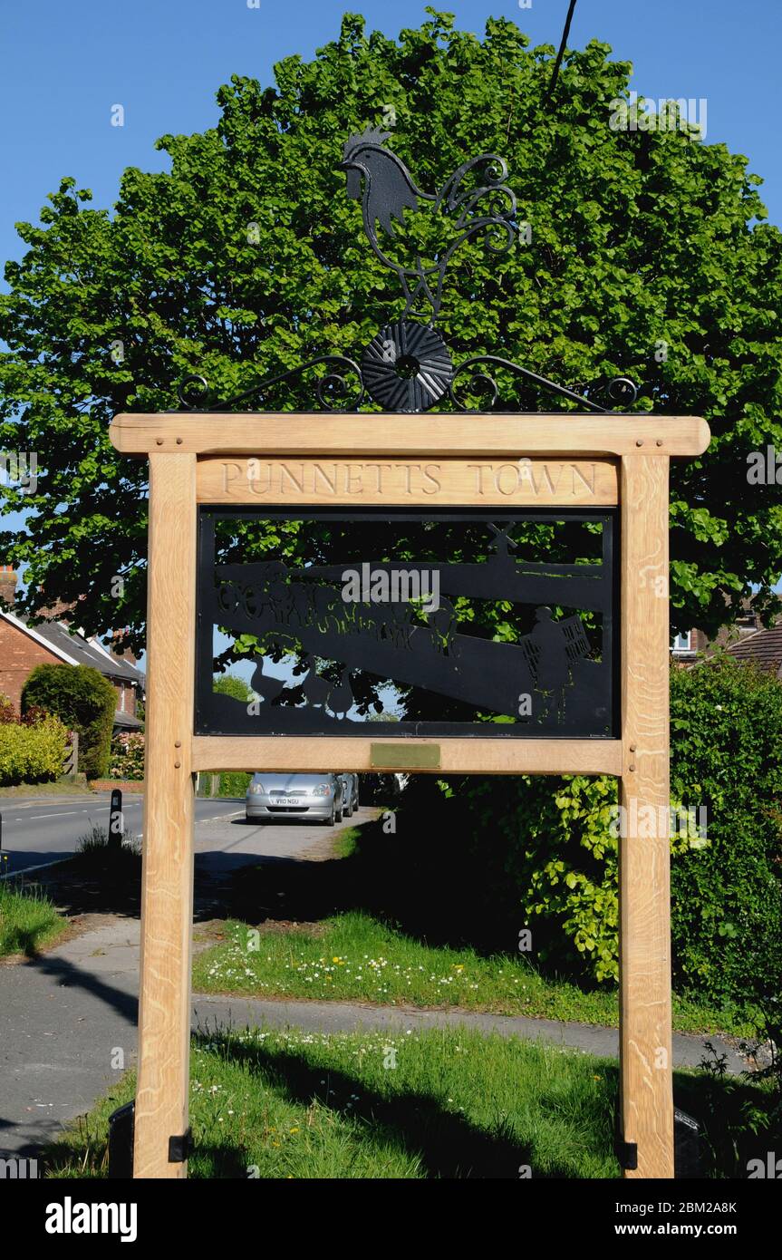 The village sign, erected in 2020, in the centre of the small East Sussex village of Punnetts Town in the Sussex Weald. Stock Photo