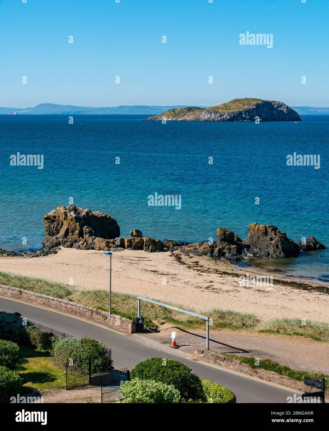 North Berwick, East Lothian, Scotland, United Kingdom. 6th May, 2020. On the warmest sunniest day of the year so far, the normally popular seaside town is almost deserted. East beach in Milsey Bay is unusually quiet and the entrance to the beach carpark is cordoned off during the Covid-19 Coronavirus pandemic lockdown Stock Photo