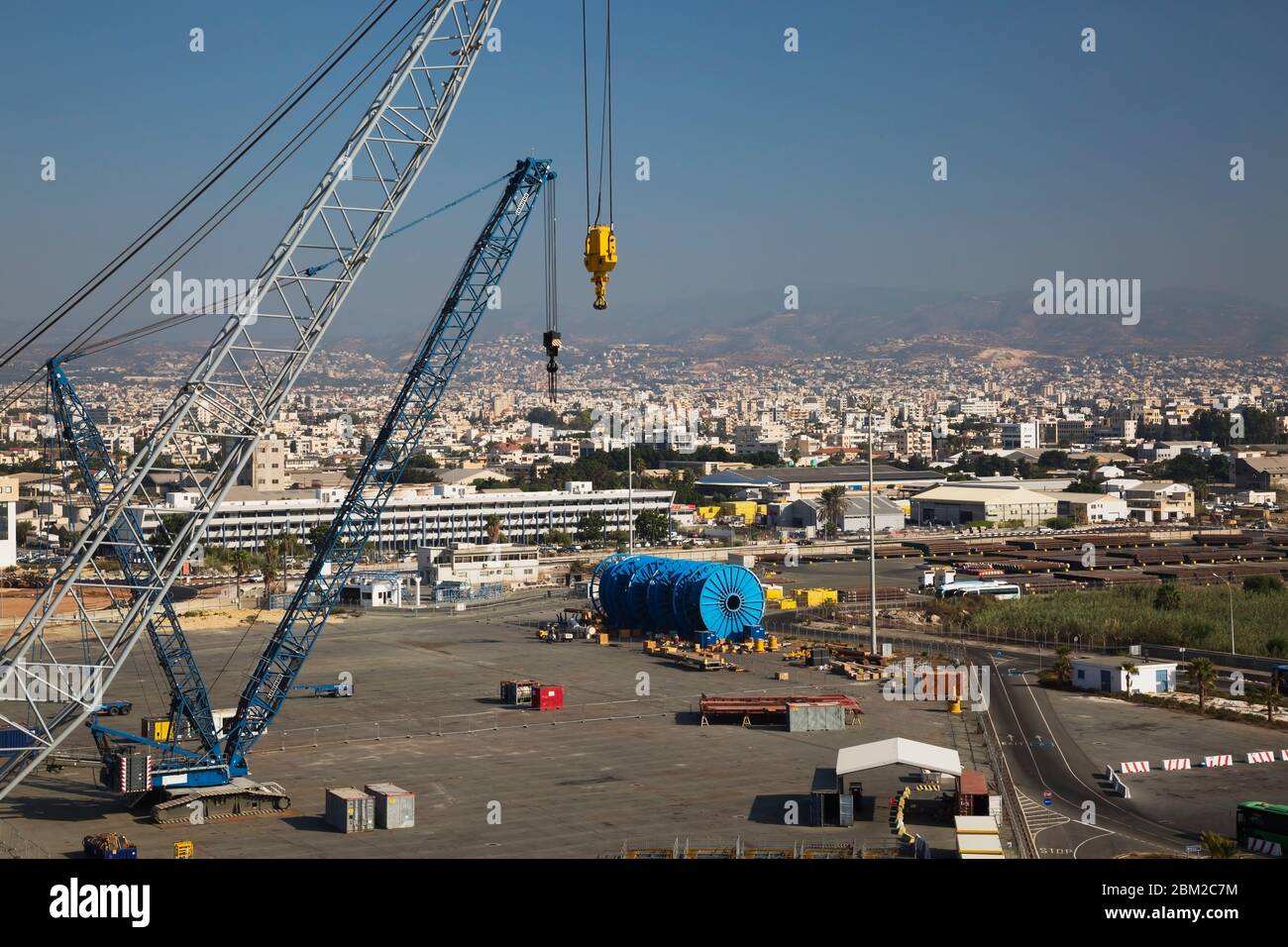Dock with cranes and blue spools of industrial cables, Limassol port