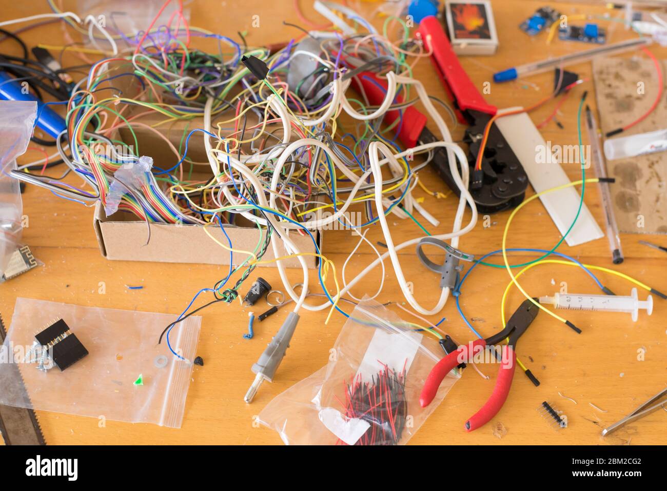 Different electrical wires and other tools on the desktop for working with electronics Stock Photo