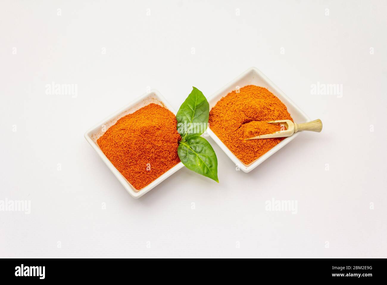 Two types of Hungarian paprika powder, hot and sweet, isolated on white