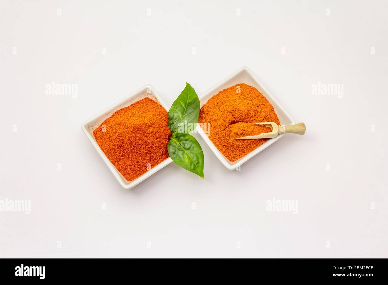 Two types of Hungarian paprika powder, hot and sweet, isolated on white background. Traditional