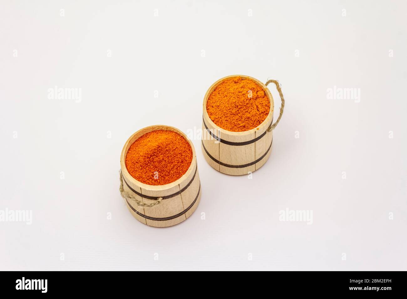 Two types of Hungarian paprika powder, hot and sweet, isolated on white background. Traditional