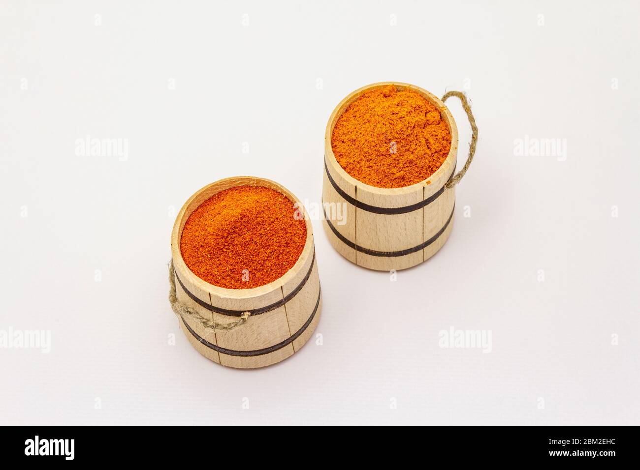 Two types of Hungarian paprika powder, hot and sweet, isolated on white