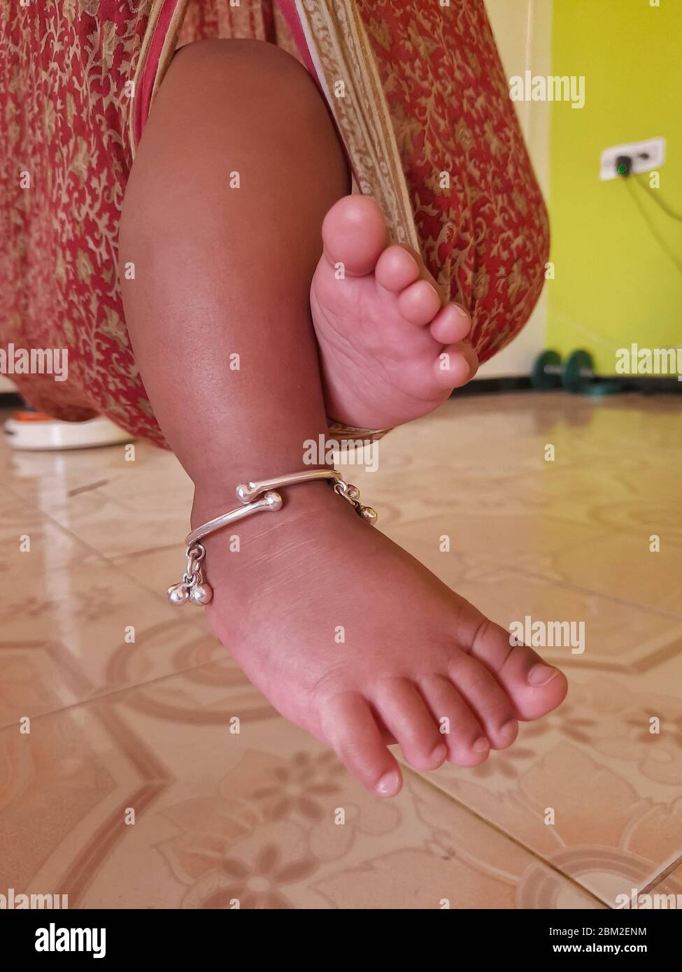 Sleeping Baby legs close up on cloth swings at room. Baby leg on air