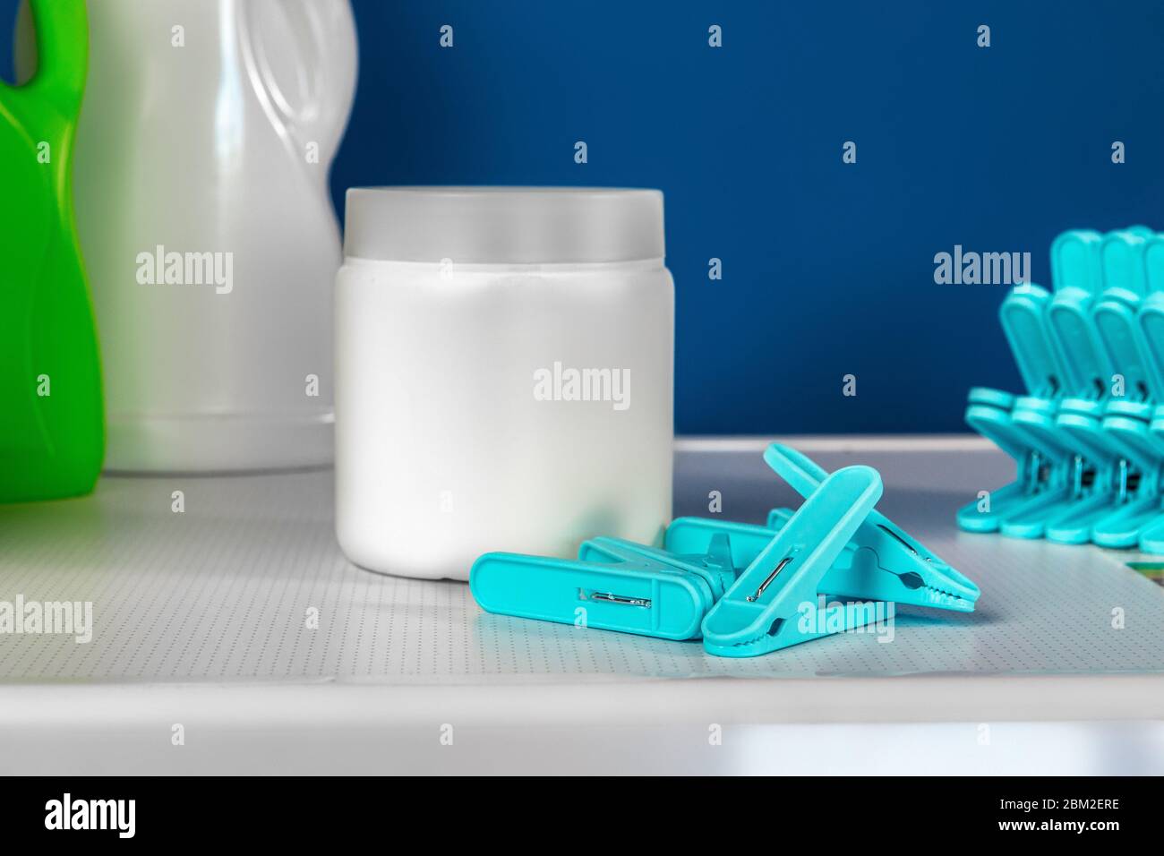 Blue clothes pins on white washing machine Stock Photo Alamy