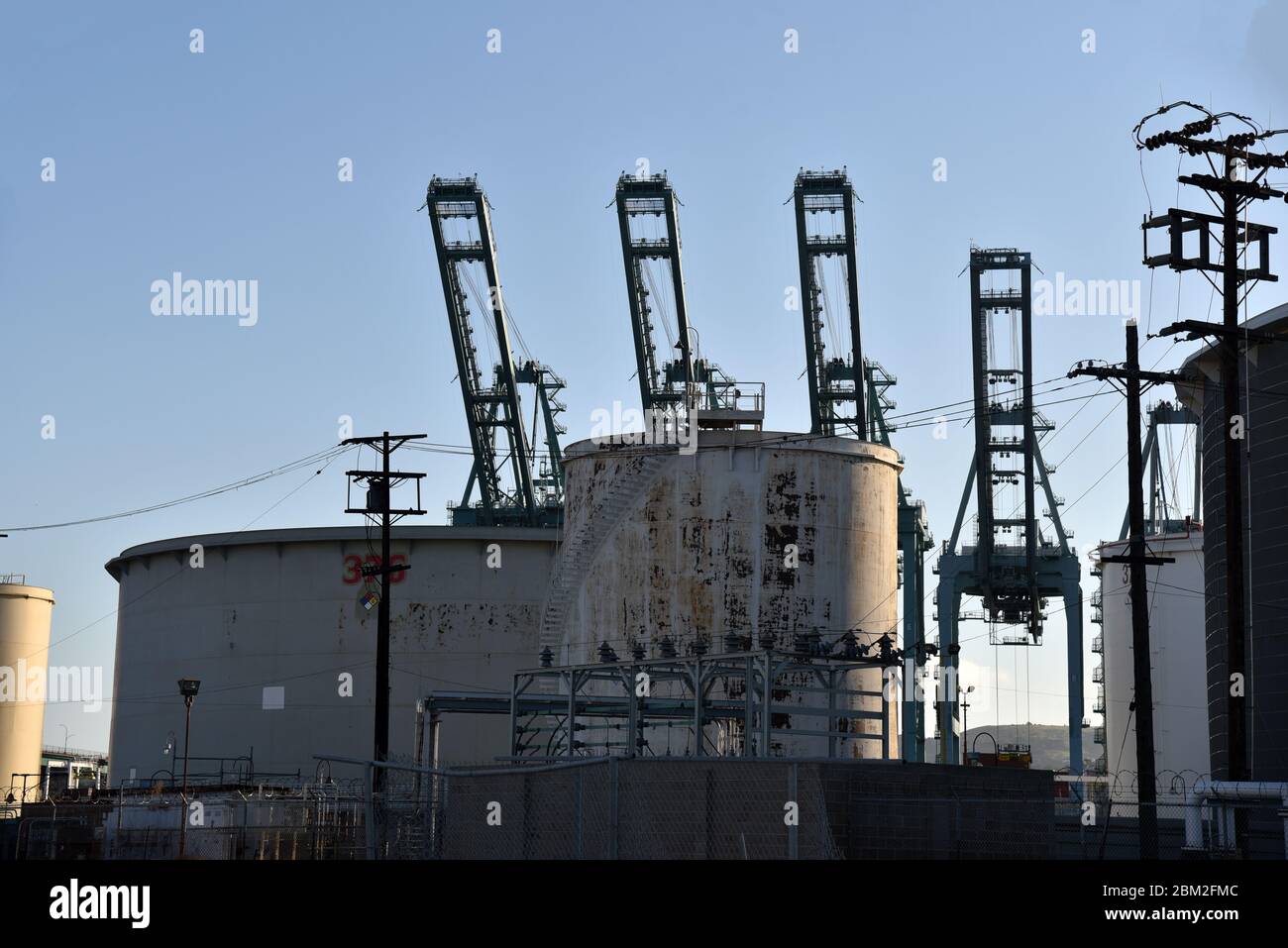 Los Angeles, CA/USA May 2, 2020 Oil storage tanks and gantry cranes