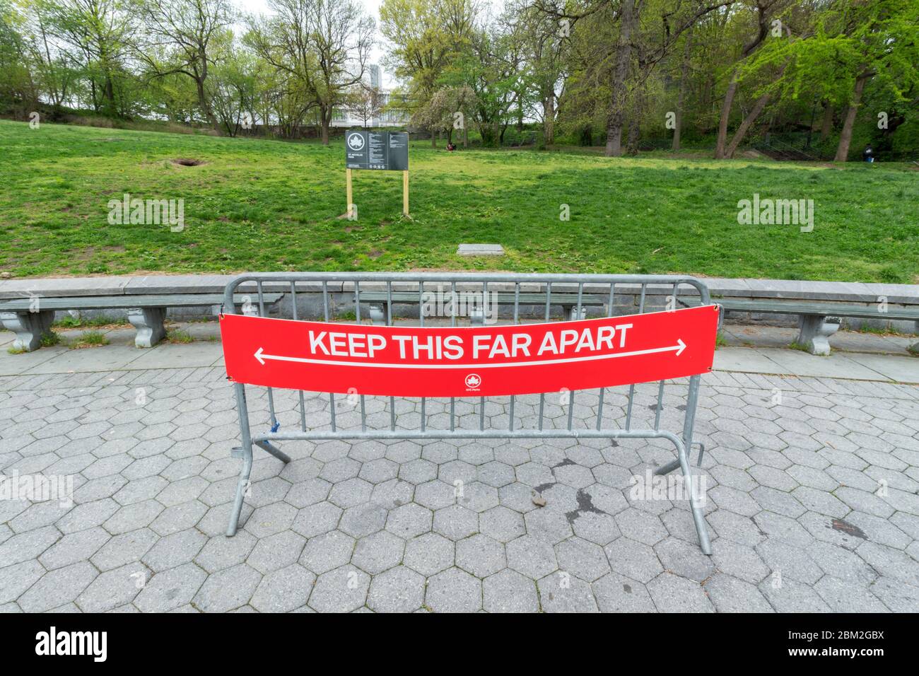 sign in parks stating keep this far apart, measuring six feet to guide social distancing when outdoors due to the coronavirus or covid-19 pandemic Stock Photo