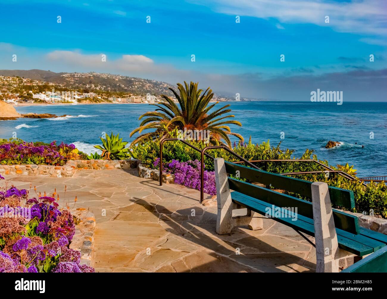 A park bench sits in one of the many overlook areas in Laguna Beach. It is a small  city in Orange County, California. It’s known for it's beauty. Stock Photo