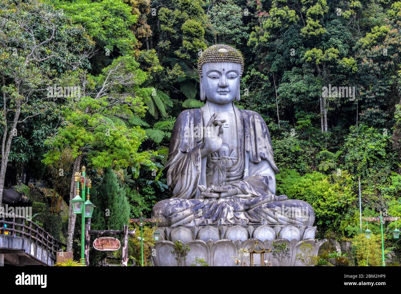 A large Buddha statue sits on a mountain edge in the Genting Highlands in Pahang, Malaysia. The Chin Swee Caves Temple is situated in Genting Highland. Stock Photo