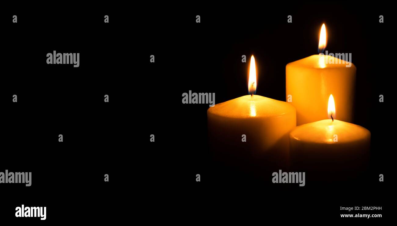 Flame candles isolated on black background Stock Photo - Alamy