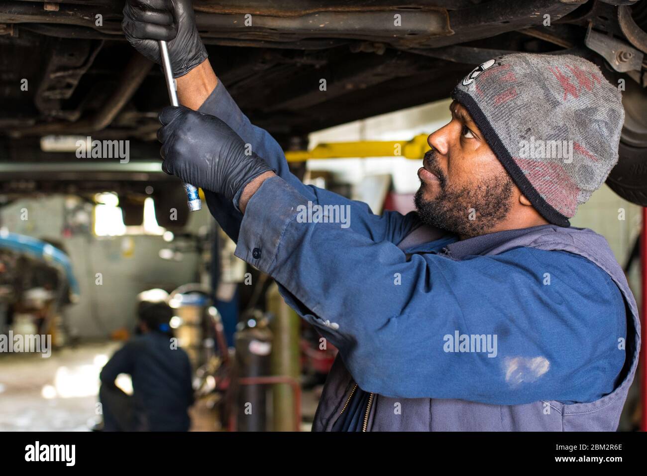 May 5, 2020: May 05, 2020: RESTEM MOHAMMED services a car in his auto repair  shop in Scarborough, Toronto. Auto mechanic shops for vehicle repair &  maintenance are considered essential services during