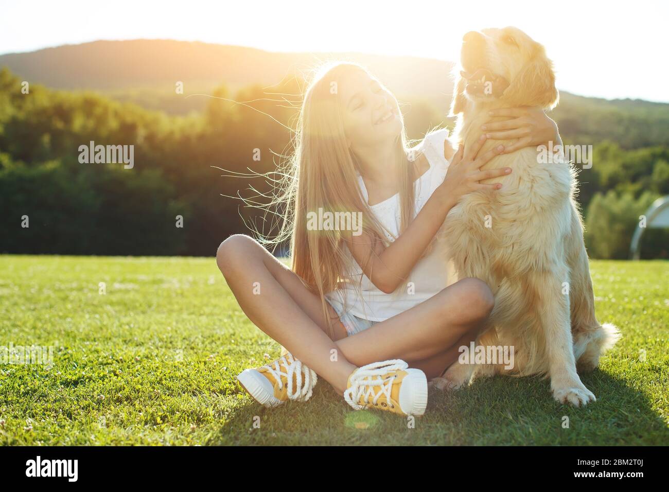 Child girl play with a dog in nature Stock Photo - Alamy