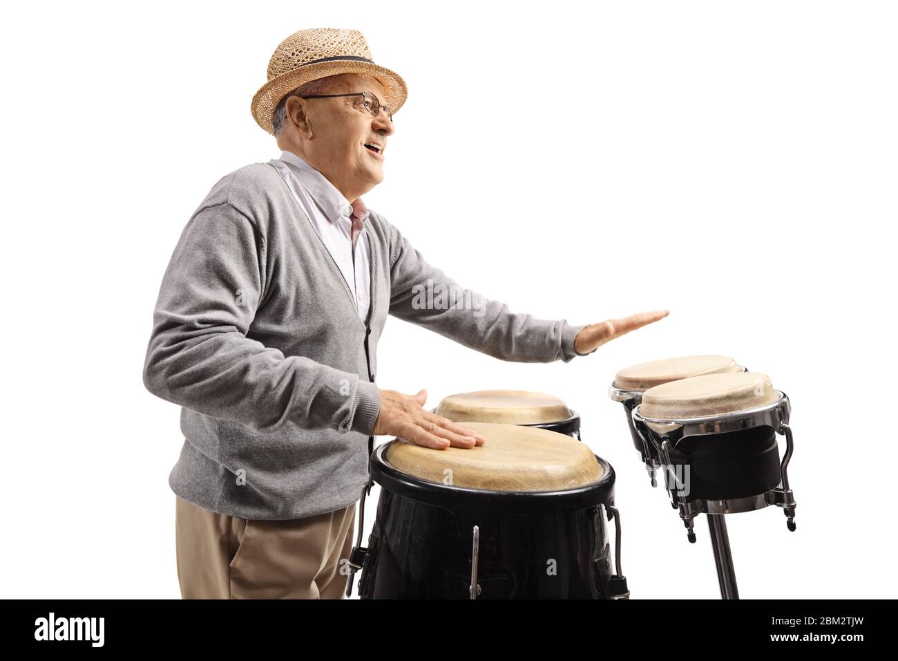Elderly man playing conga drums isolated on white background Stock Photo