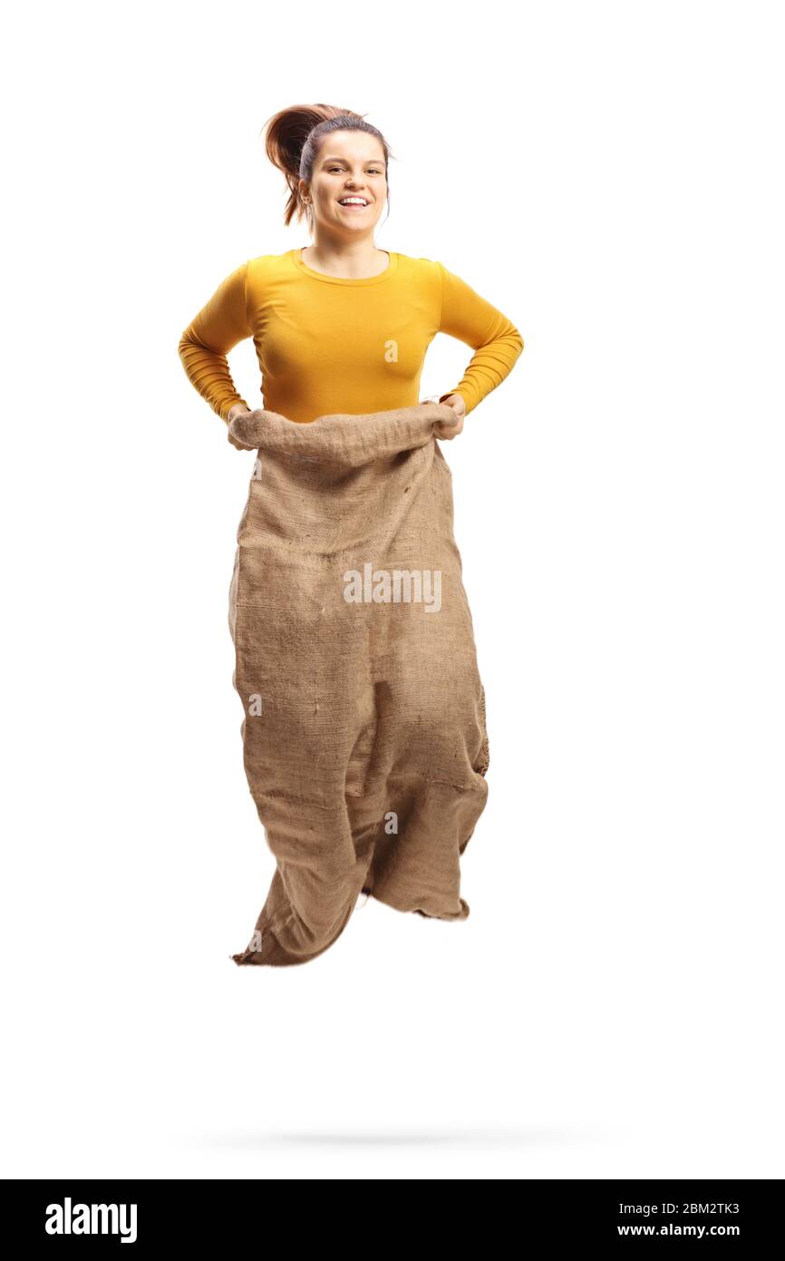 Young woman smiling and jumping in a sack playing gunny race isolated
