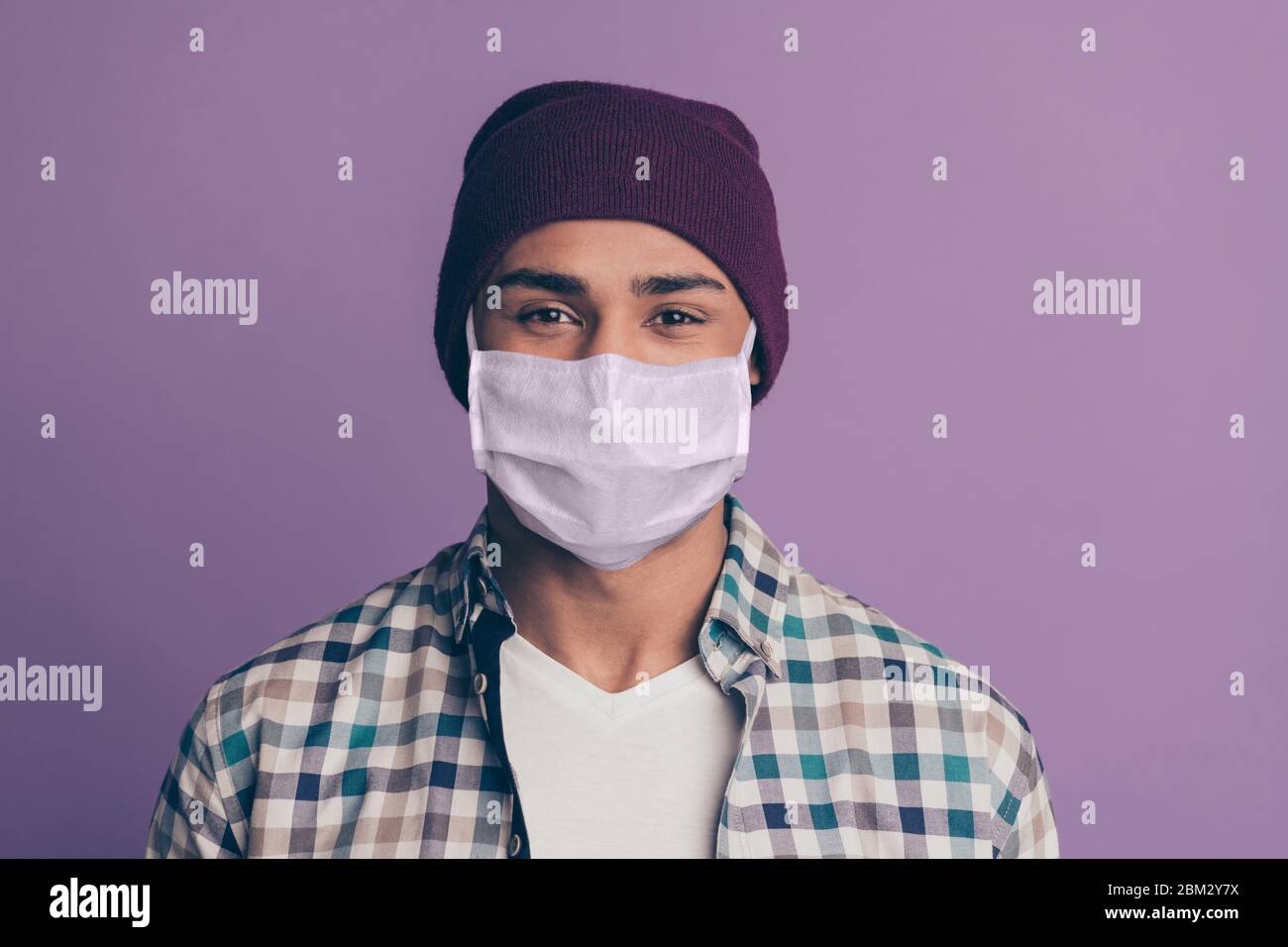 Close up photo amazing funky macho guy stay home covid-19 quarantine look wearing medical mask casual plum color headwear checkered plaid shirt Stock Photo