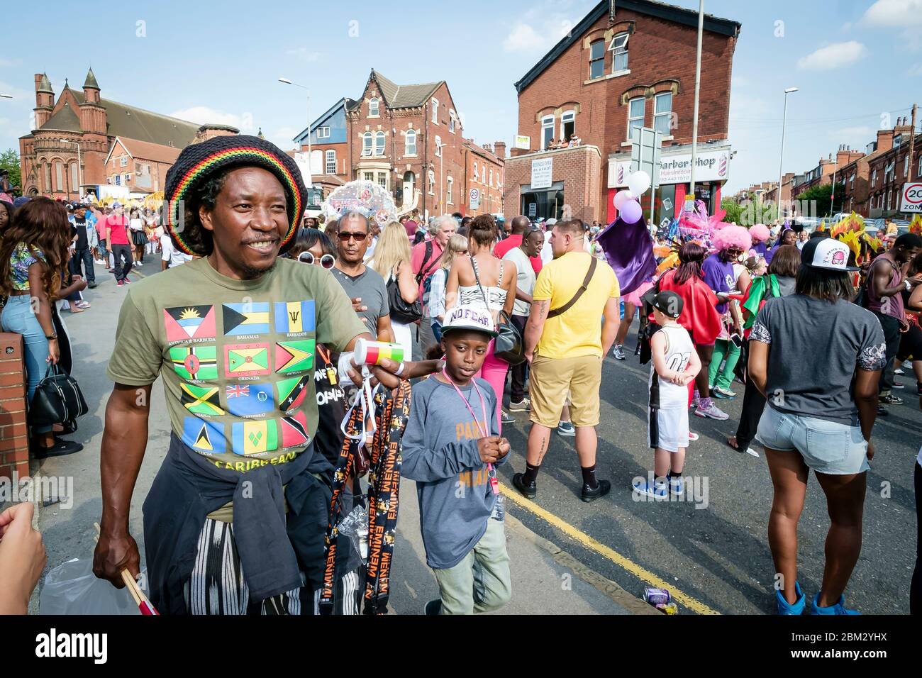 Street scene with man in rasta hat at the Chapeltown - Leeds West Indian Carnival Stock Photo
