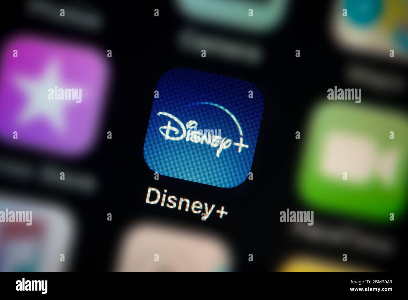 A close-up shot of the Disney+ app icon, as seen on the screen of a smart phone (Editorial use only) Stock Photo