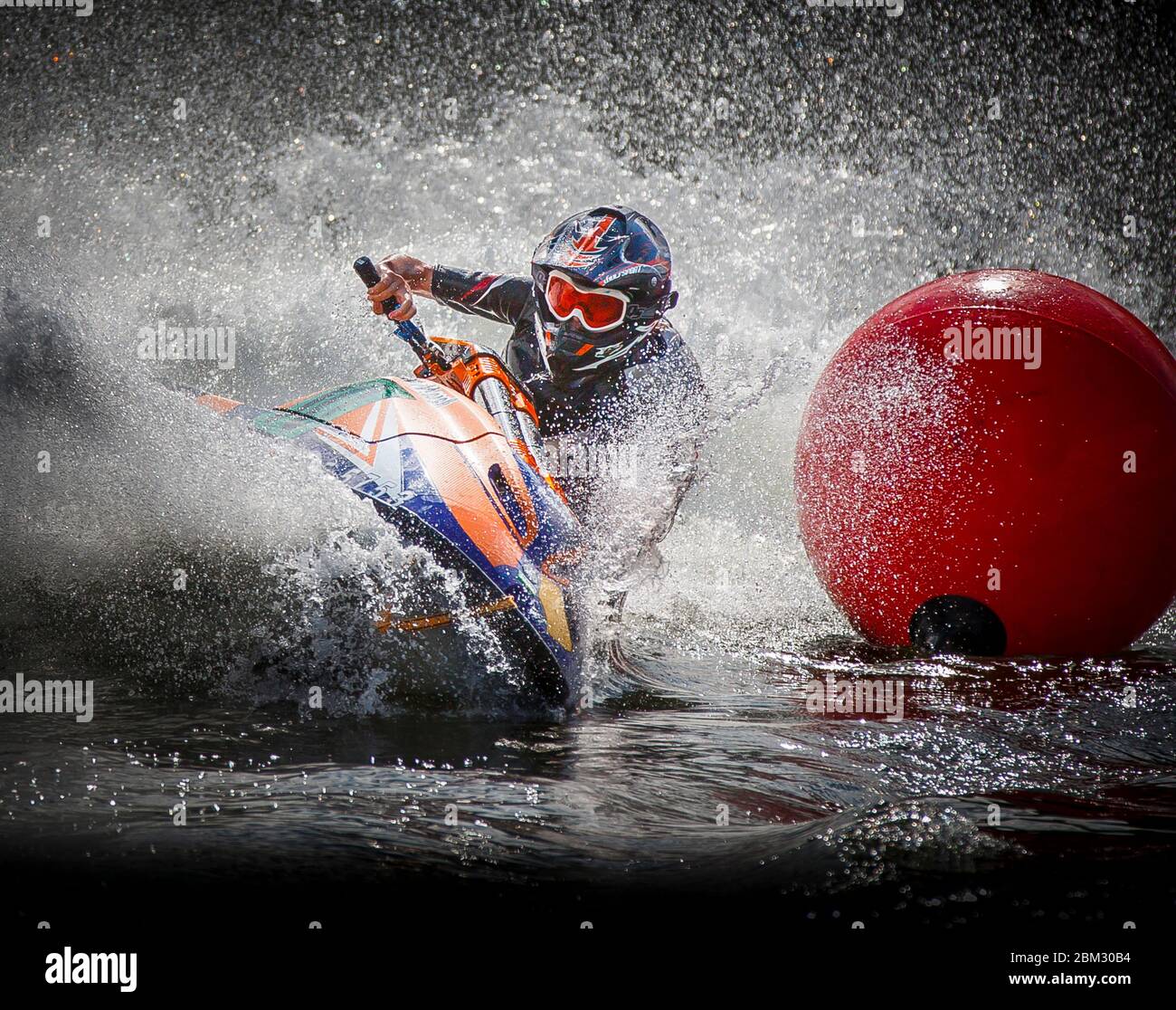 Jetski racing action shot, cornering around buoy amid dramatic water spray Stock Photo
