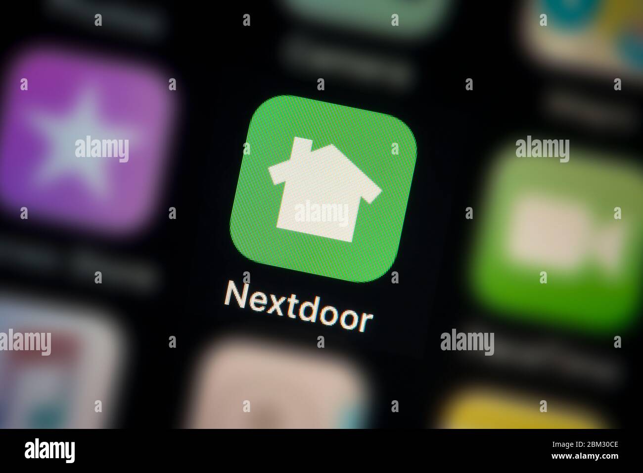 A close-up shot of the Nextdoor app icon, as seen on the screen of a smart phone (Editorial use only) Stock Photo