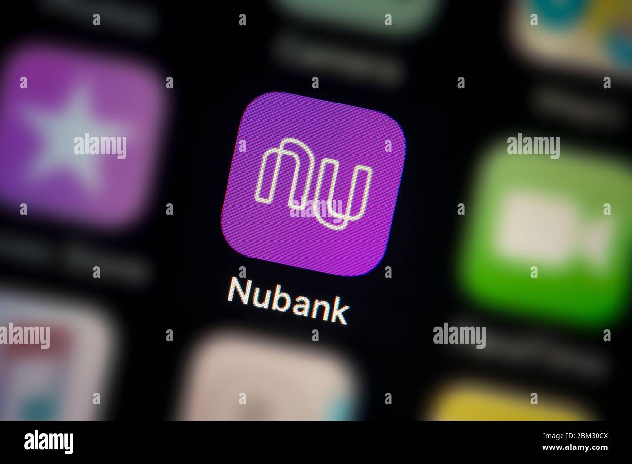 A close-up shot of the Nubank app icon, as seen on the screen of a smart phone (Editorial use only) Stock Photo