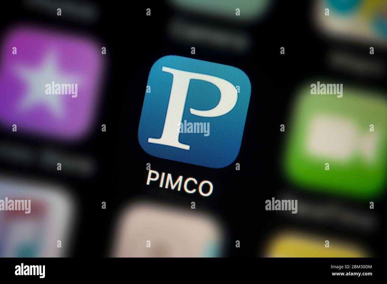 A close-up shot of the Pimco app icon, as seen on the screen of a smart phone (Editorial use only) Stock Photo