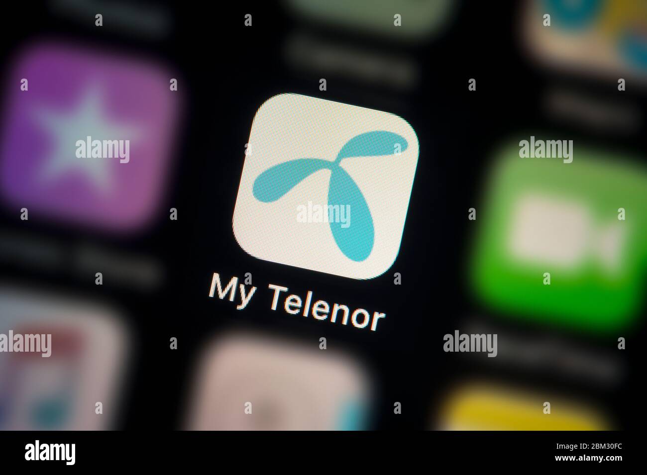 A close-up shot of the Telenor app icon, as seen on the screen of a smart phone (Editorial use only) Stock Photo