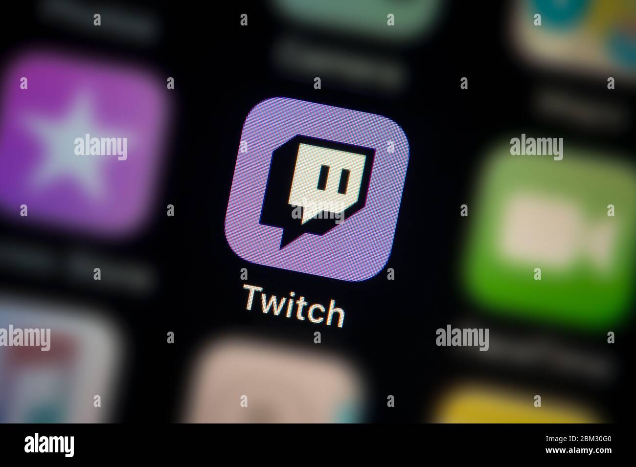 A close-up shot of the Twitch app icon, as seen on the screen of a smart phone (Editorial use only) Stock Photo