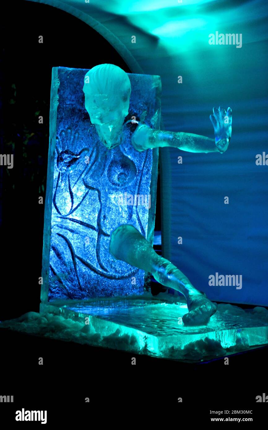 Ice sculpture of young lady lights in the night Stock Photo