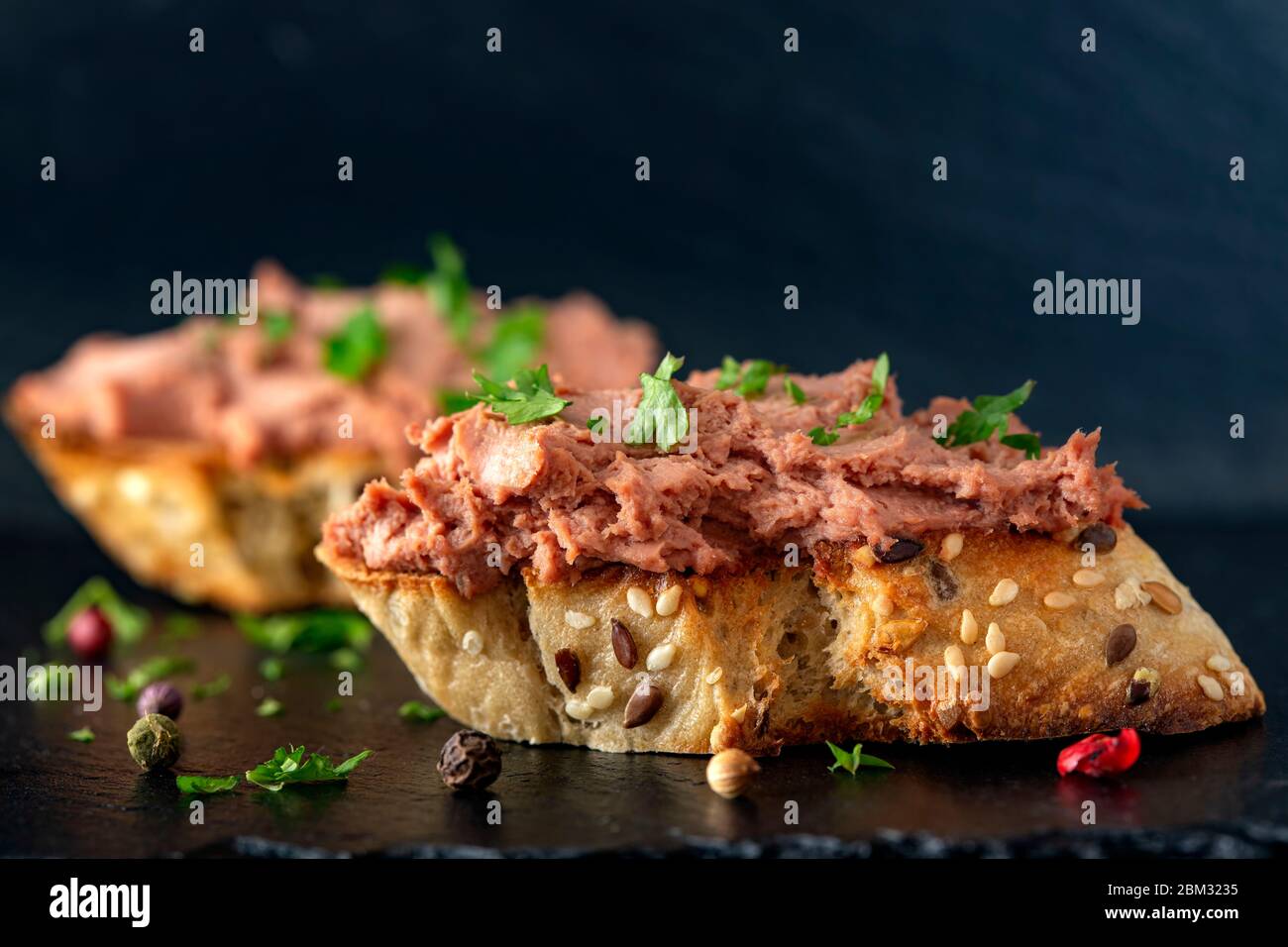 Toast with meat pate and herbs Stock Photo