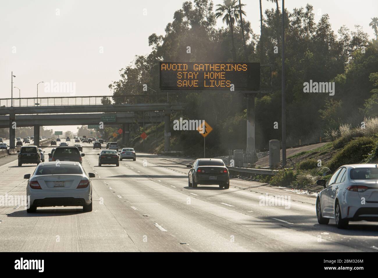 Los Angeles, California, USA. 3rd May, 2020. A sign asks citizens to avoid gatherings as people go about daily life under COVID-19 restrictions in Los Angeles, California, on Sunday, May 3. Photo by Justin L. Stewart Credit: Justin L. Stewart/ZUMA Wire/Alamy Live News Stock Photo