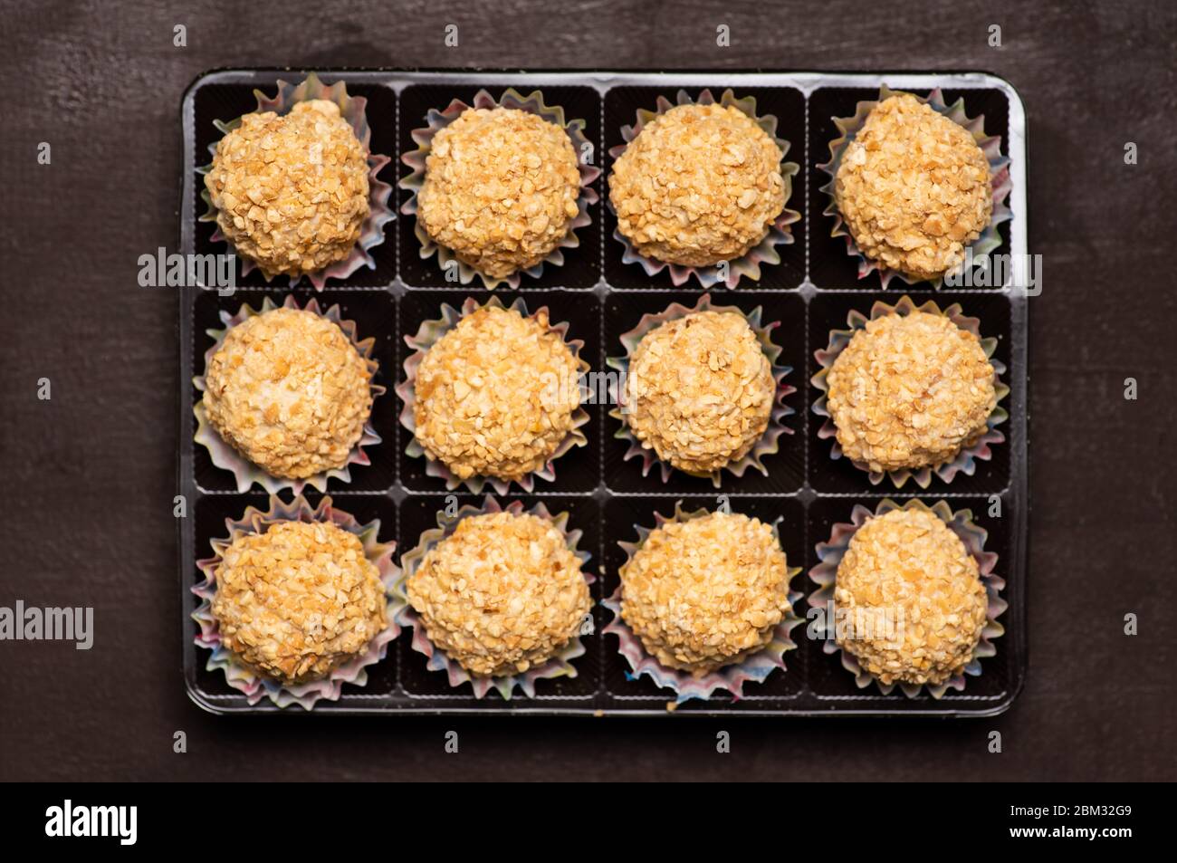 Homemade balls dessert sprinkled with hazelnut stuffed with chocolate Stock Photo
