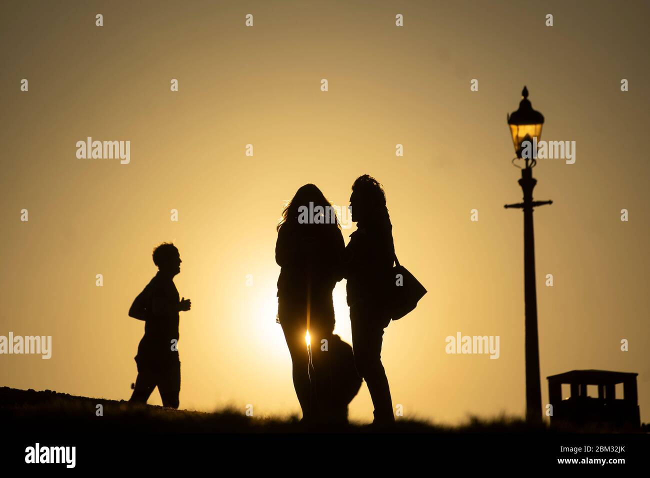People wait for the moon to rise over Primrose Hill in central London, ahead of the final supermoon of the year, which will be visible over the UK on Thursday evening. The full moon in May is also known as the 'flower moon', signifying the flowers that bloom during the month. Stock Photo